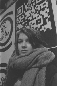 Portrait of woman standing against wall