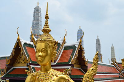 Low angle view of temple against cloudy sky