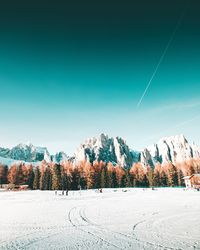 Scenic view of snow covered field against sky