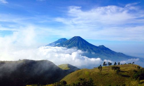 Scenic view of mountains against cloudy sky