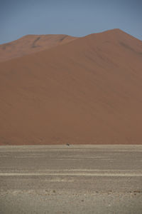 Scenic view of desert against clear sky