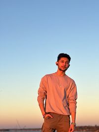 Man standing against clear sky during sunset
