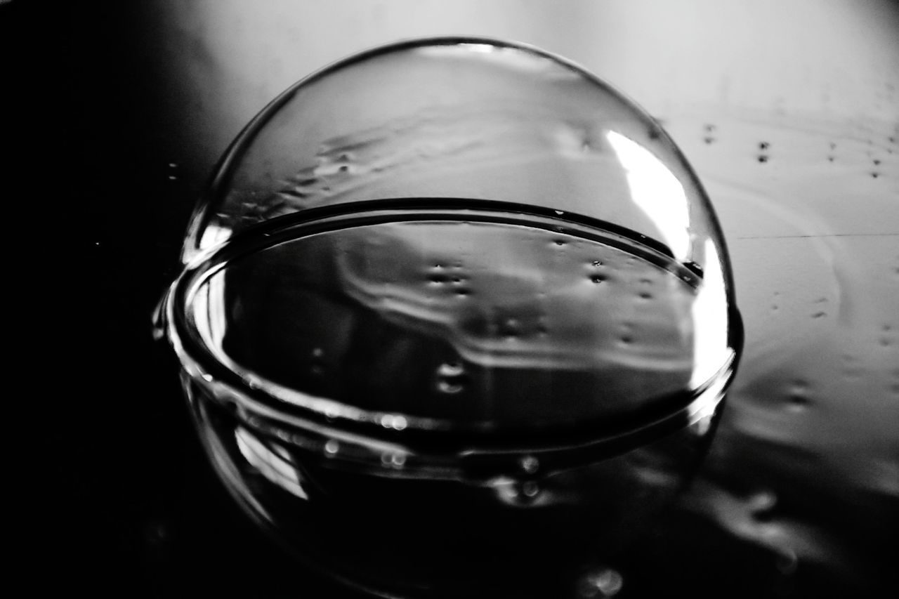 reflection, close-up, transparent, glass - material, no people, indoors, focus on foreground, still life, shape, high angle view, household equipment, glass, water, directly above, drinking glass, food and drink, geometric shape, circle, drink