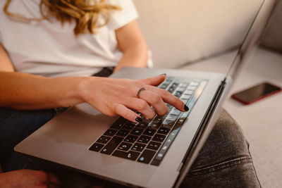 Midsection of woman using mobile phone