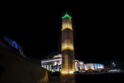 Low angle view of illuminated tower at night