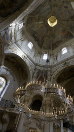 Low angle view of illuminated chandelier in building