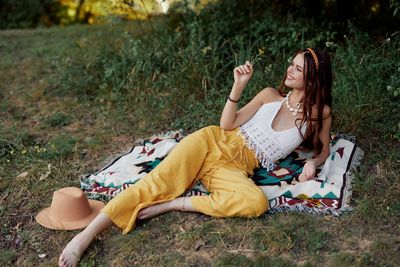 Young woman sitting on field