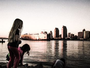 Man with arms raised against cityscape in background