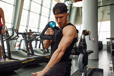 Side view of man exercising in gym