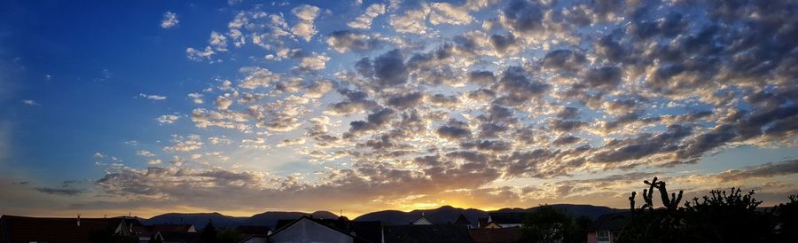 Low angle view of silhouette buildings against sky during sunset