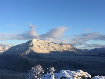 Scenic view of snow covered mountains against sky