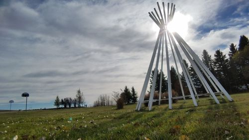 Windmill on field against sky