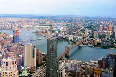 High angle view of river amidst buildings in city against sky