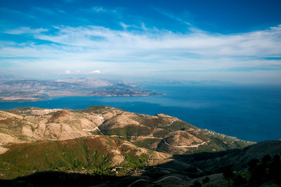 Scenic view of sea and mountains against sky