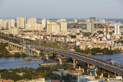 High angle view of bridge over river in city against clear sky