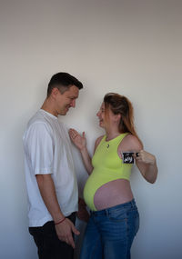 Side view of mother and daughter at home