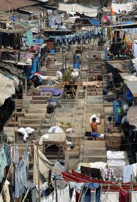 High angle view of clothes hanging by people at mahalaxmi dhobi ghat