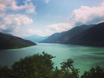 Scenic view of lake and mountains against sky