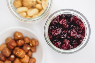 Overhead view of raisins and nuts on white table