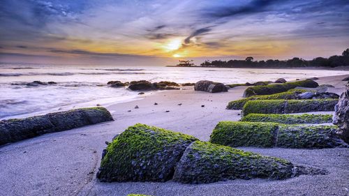 Scenic view of beach against sky during sunset