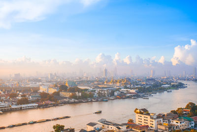 High angle view of commercial dock by river against sky