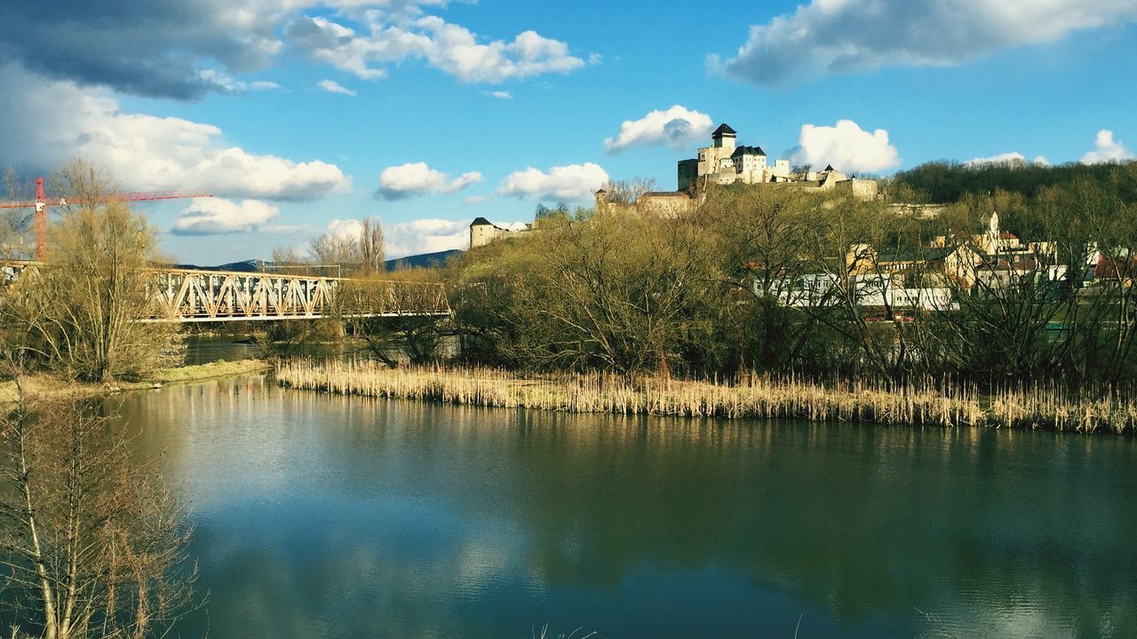 architecture, built structure, building exterior, water, sky, tree, reflection, lake, cloud - sky, waterfront, house, river, cloud, tranquility, nature, day, tranquil scene, residential structure, outdoors, scenics