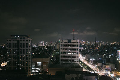 High angle view of city lit up at night