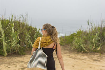 Rear view of woman standing on grass