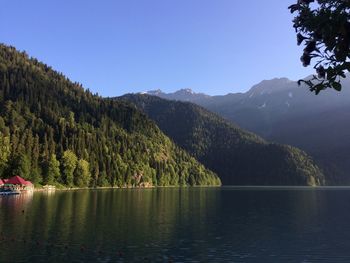 Scenic view of lake and mountains against clear sky