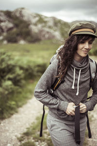 Young woman walks and smiles with backpack