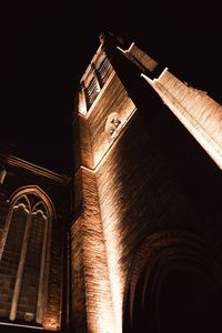 Low angle view of illuminated building against sky at night