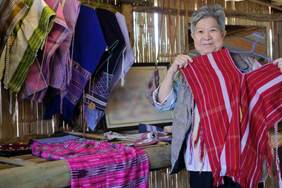 Portrait of smiling senior woman shopping in store