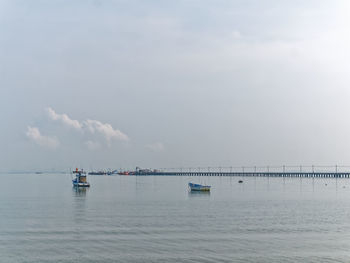 Fishing boats floating on the sea at the pier