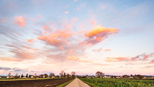 Scenic view of field against sky during sunset