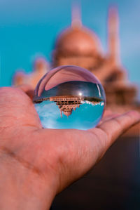 Close-up of person hand holding swimming pool