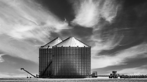 Grain silos with a cloudy sky in black and white