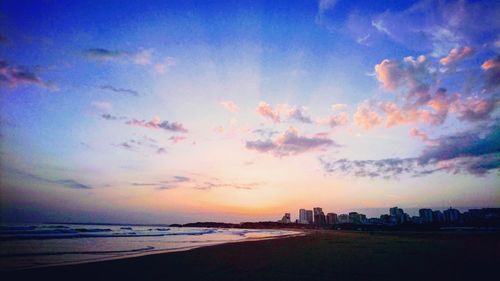 Scenic view of beach against sky during sunset