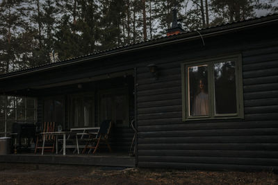 Female ghost seen through window of haunted cabin