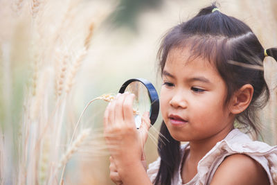 Portrait of cute girl holding plant