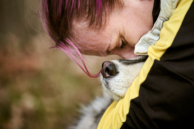 Close-up of young woman with dog