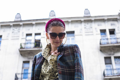 Young woman with sunglasses posing in the street