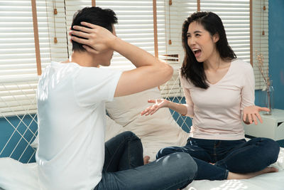 Young couple sitting at home