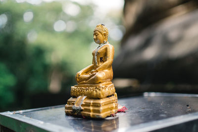 Close-up of buddha figurine on table