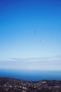 High angle view of airplane flying over sea