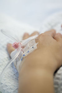 Cropped image of patient with iv drip at hospital