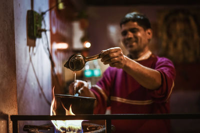 Indian man making tea in restaurant
