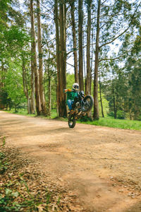 Man riding bicycle on dirt road