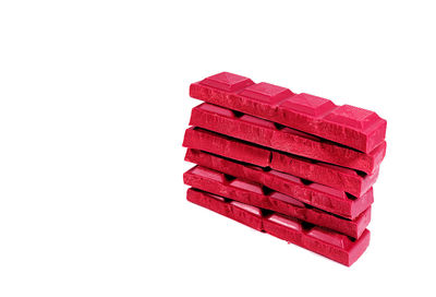 Close-up of red stack against white background