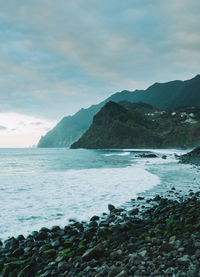 Scenic view of sea and mountains against sky