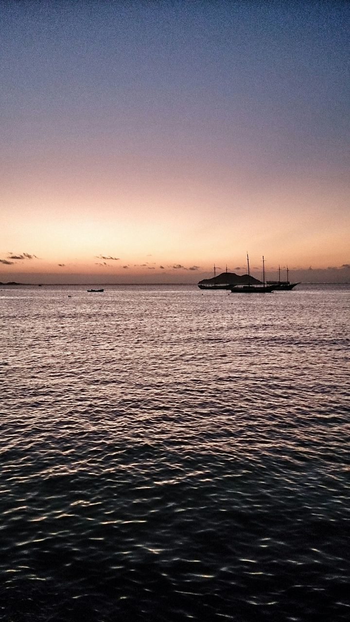 sea, water, sunset, horizon over water, tranquil scene, scenics, waterfront, tranquility, beauty in nature, silhouette, rippled, nature, sky, copy space, idyllic, nautical vessel, clear sky, dusk, transportation, seascape